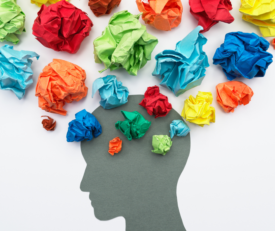 gray silhouette of a head with colored balls of paper coming out like ideas