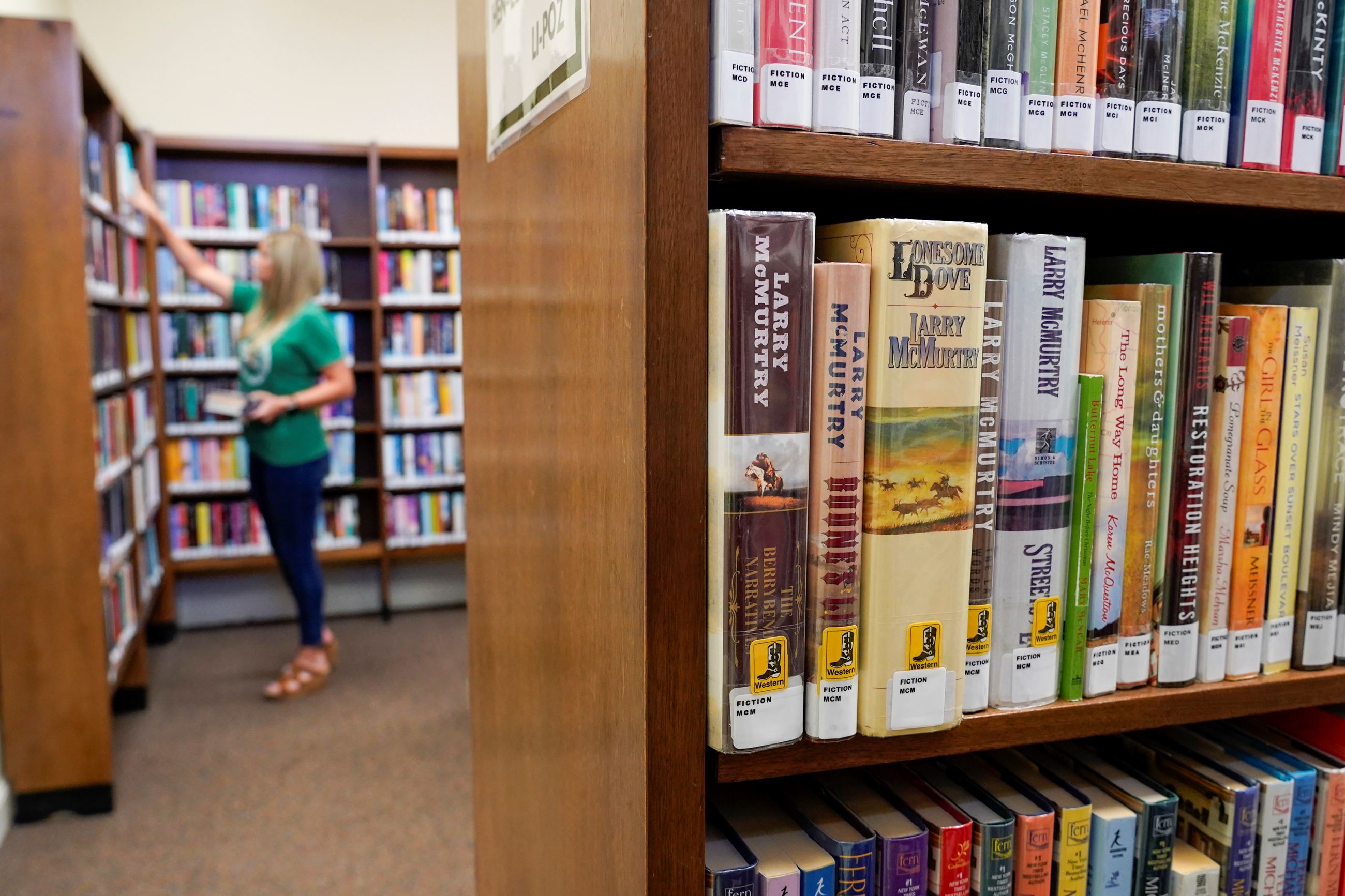 Library staff member shelving books at Lake Elmo Library.