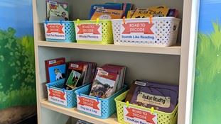 Road to Decode books sit in baskets on a shelf at RH Stafford Library. 