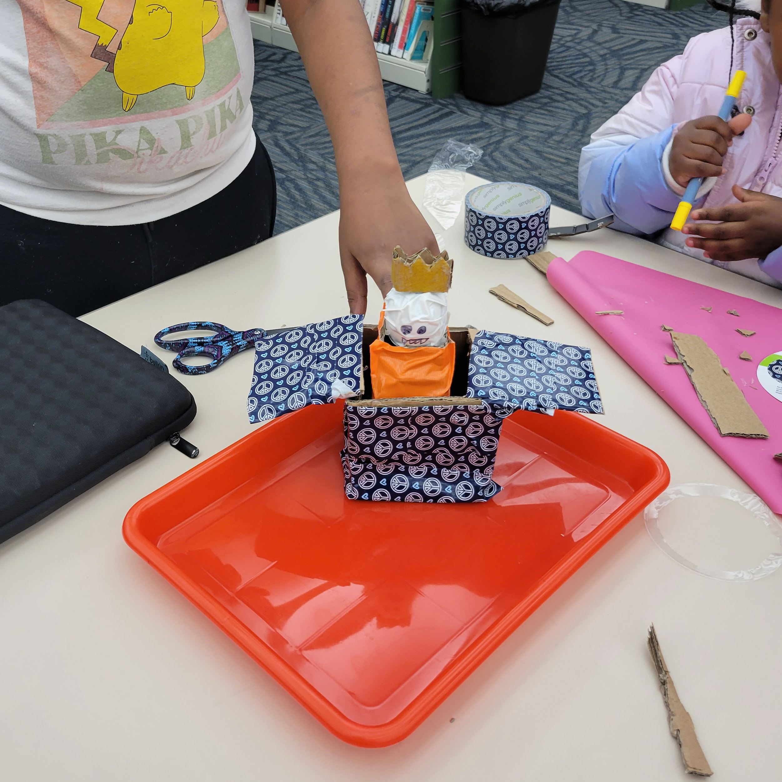 Tween showing a Jack in the Box made from construction paper and colored paper
