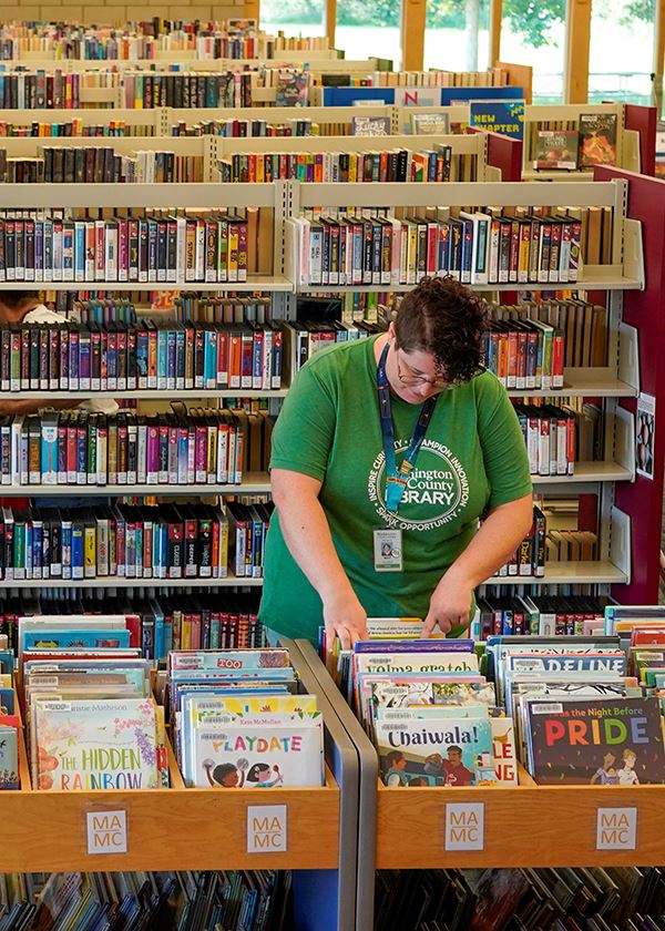 Librarian organizing children's books at Oakdale Library