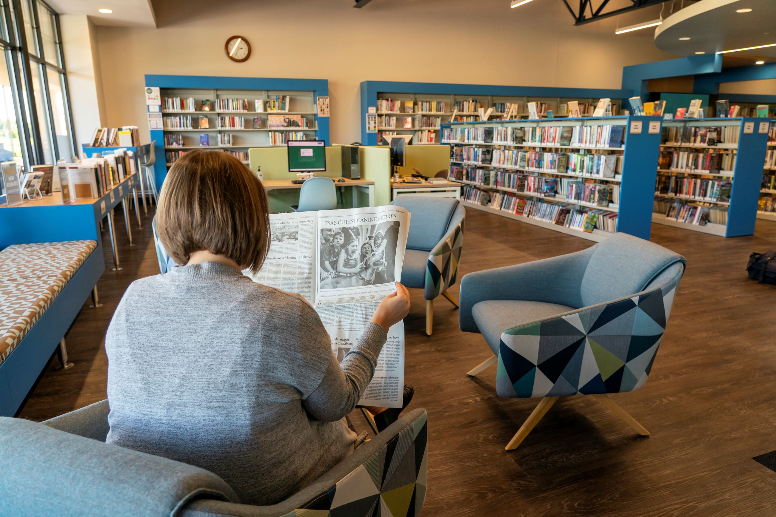 Woman reading the newspaper at Valley Library.